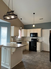 Great house with a corner fireplace that can be viewed from the kitchen and the family room.