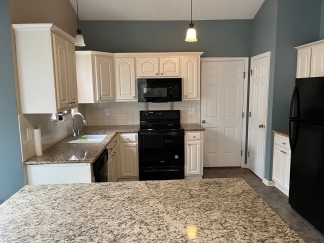 Great house with a corner fireplace that can be viewed from the kitchen and the family room.