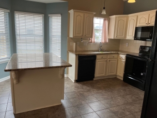 Great house with a corner fireplace that can be viewed from the kitchen and the family room.