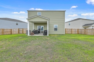 Like-New Pond Lot Home with First-Floor Primary Suite