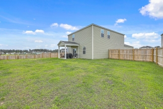 Like-New Pond Lot Home with First-Floor Primary Suite