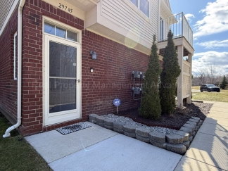 Rare Corner Upper Condo with Vaulted Ceilings, Private Balcony and 2 Car Garage - Right Across from the GM Tech Center!