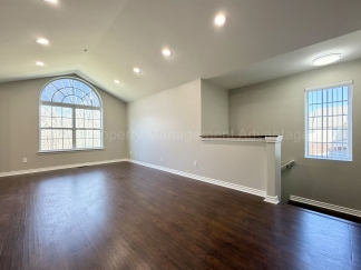 Rare Corner Upper Condo with Vaulted Ceilings, Private Balcony and 2 Car Garage - Right Across from the GM Tech Center!