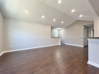 Rare Corner Upper Condo with Vaulted Ceilings, Private Balcony and 2 Car Garage - Right Across from the GM Tech Center!