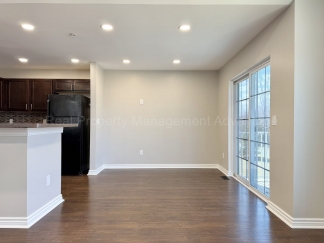 Rare Corner Upper Condo with Vaulted Ceilings, Private Balcony and 2 Car Garage - Right Across from the GM Tech Center!