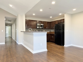 Rare Corner Upper Condo with Vaulted Ceilings, Private Balcony and 2 Car Garage - Right Across from the GM Tech Center!