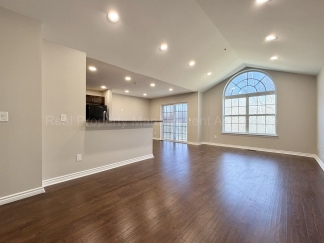 Rare Corner Upper Condo with Vaulted Ceilings, Private Balcony and 2 Car Garage - Right Across from the GM Tech Center!
