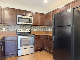 Rare Corner Upper Condo with Vaulted Ceilings, Private Balcony and 2 Car Garage - Right Across from the GM Tech Center!