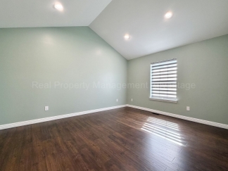 Rare Corner Upper Condo with Vaulted Ceilings, Private Balcony and 2 Car Garage - Right Across from the GM Tech Center!