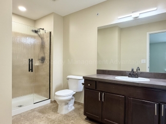Rare Corner Upper Condo with Vaulted Ceilings, Private Balcony and 2 Car Garage - Right Across from the GM Tech Center!