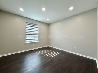Rare Corner Upper Condo with Vaulted Ceilings, Private Balcony and 2 Car Garage - Right Across from the GM Tech Center!